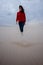 Young beautiful woman is walking through the desert in a cloud o