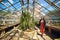 Young beautiful woman walking on greenhouse in Botanical Garden of the University, Wroclaw, Poland