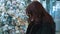 A young beautiful woman walks around the store and selects Christmas decorations and decorations to celebrate the New