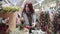 A young beautiful woman walks around the store and selects Christmas decorations and decorations to celebrate the New