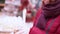 A young beautiful woman walks around the store and selects Christmas decorations and decorations to celebrate the New Year and Chr