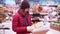 A young beautiful woman walks around the store and selects Christmas decorations and decorations to celebrate the New Year and Chr