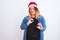 Young beautiful woman wearing Christmas Santa hat standing over isolated white background disgusted expression, displeased and