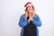 Young beautiful woman wearing Christmas Santa hat standing over  white background begging and praying with hands together