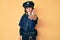 Young beautiful woman wearing police uniform smiling friendly offering handshake as greeting and welcoming