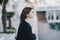 Young beautiful woman wearing total black clothes standing on the city embankment