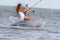 Young beautiful woman in wedding dress kitesurfing