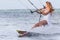 Young beautiful woman in wedding dress kitesurfing