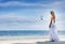 Young beautiful woman in wedding dress on tropical beach
