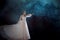 Young beautiful woman in wedding dress with wide light skirt. Dark background, fantasy style.