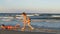 Young beautiful women enjoying teasing one another on a beautiful wet sandy beach