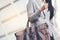 Young beautiful working woman holding bag in the city