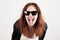 Young beauty hipster woman screaming and showing tongue, funny face with sunglasses