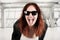 Young beauty hipster woman screaming and showing tongue, funny face with sunglasses