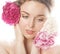 Young beauty woman with flower peony pink closeup