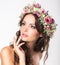 Young Beauty. Woman\'s Face with Bouquet of Natural Flowers