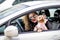 Young beauty woman in sunglasses and small dog yorkshire terrier in clothes in car. Funny dog traveling. Vacation with pet concept