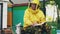 Young beekeeper man write in notepad checking harvest while sitting near beehives