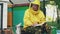 Young beekeeper man write in notepad checking harvest while sitting near beehives