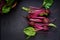 Young beetroot with a tops on a dark background.