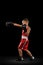 Young beginner boxer, sportive boy training isolated over dark background. Concept of sport, movement, studying