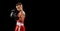 Young beginner boxer, sportive boy training isolated over dark background. Concept of sport, movement, studying