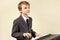 Young beginner musician in a suit playing electronic piano