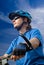 Young biker in helmet on a blue sky background