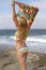 Young bikini clad blonde woman vacationing at the beach