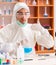 Young biochemist wearing protective suit working in the lab