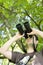 Young bird watcher holding binoculars