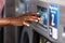 Young black African American woman  hand close up using a washing machine in a laundry