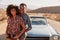 Young black couple on road trip having a roadside stop off