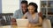 Young black couple using tablet at desk