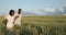 Young black couple walking through green field