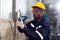 Young black engineer man examining and measuring steel with expertise at lathe factory.