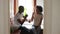 Young black family couple in bathroom enjoy brushing teeth