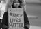 A Young Black Female Protester holding A sign at a Black Lives Matter anti-racism protest march on June 6 2020 in Swindon UK.