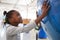 Young black girl holding a giant globe at a science centre