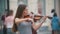 Young black hair woman playing a violin at the pedestrian street