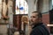 Young black-haired man in a Catholic church enthusiastically sights