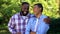 Young black man hugging younger brother laughing having fun together, family