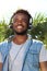 Young black man smiling with headphones outside