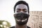 Young black man wearing face mask during equal rights protest - Concept of demonstrators on road for Black Lives Matter and I Can