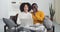 Young black smiling couple mixed race ethnic african american newlyweds husband and wife boyfriend and girlfriend sit on