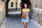 Young black tourist woman with curly hairstyle outdoors