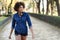 Young black woman with afro hairstyle standing in urban background