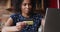 Young Black woman hold bank card make payment via laptop