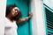 Young black woman leaning in a doorway, low angle, close up