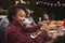 Young black woman passing bowl at a family barbecue